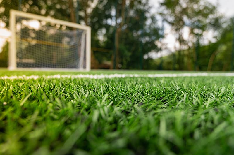 verde artificiale del campo di erba di calcio del pavimento di tappeto del  tappeto erboso di